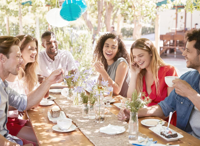 six-young-friends-dining-at-a-table-outdoors-2021-04-02-20-00-42-utc.jpg